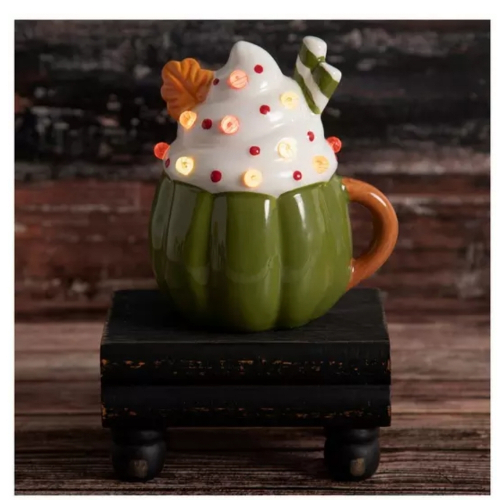 FALL PUMPKIN MUG LIGHT UP.  CERAMIC MUG WITH A SWIRL OF WHIPPED CREAM ON TOP.